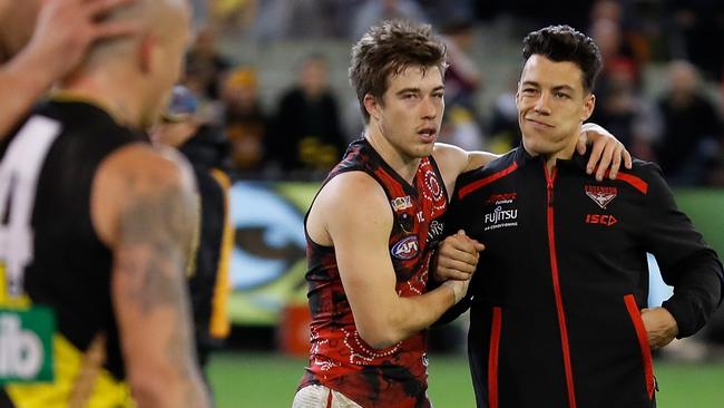 Zach Merrett (left) consoles hamstrung teammate Dylan Shiel. Pic: AFL Photos