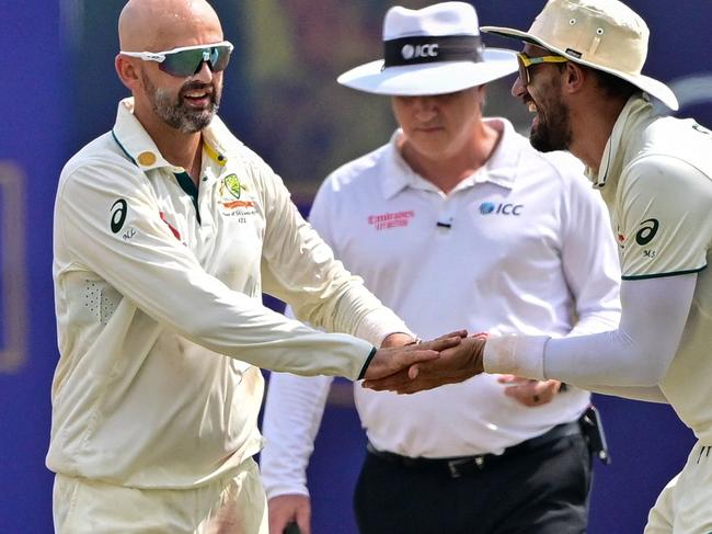 Australia's Nathan Lyon (L) celebrates with Mitchell Starc (R) after taking the wicket of Sri Lanka's Kusal Mendis during the fourth day of the first Test cricket match between Sri Lanka and Australia at the Galle International Cricket Stadium in Galle on February 1, 2025. (Photo by Ishara S. KODIKARA / AFP)