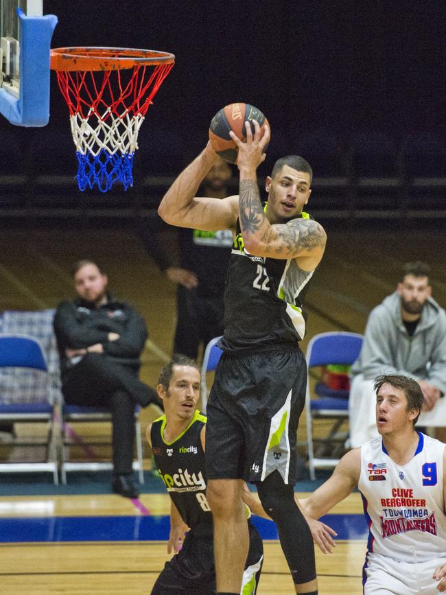 Rip City player Eric McAlister pulls down a rebound against the Toowoomba Mountaineers.