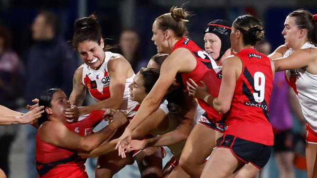 MELBOURNE, AUSTRALIA - OCTOBER 02: Players wrestle at the three quarter time siren during the 2024 AFLW Round 06 match between the Essendon Bombers and the Sydney Swans at Mission Whitten Oval on October 02, 2024 in Melbourne, Australia. (Photo by Michael Willson/AFL Photos via Getty Images)