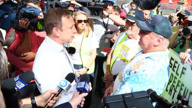 Queensland Premier Steven Miles speaks to crime victim Russell Field outside the state parliament during a Voice for Victims rally in Brisbane. Picture: NCA NewsWire/Tertius Pickard