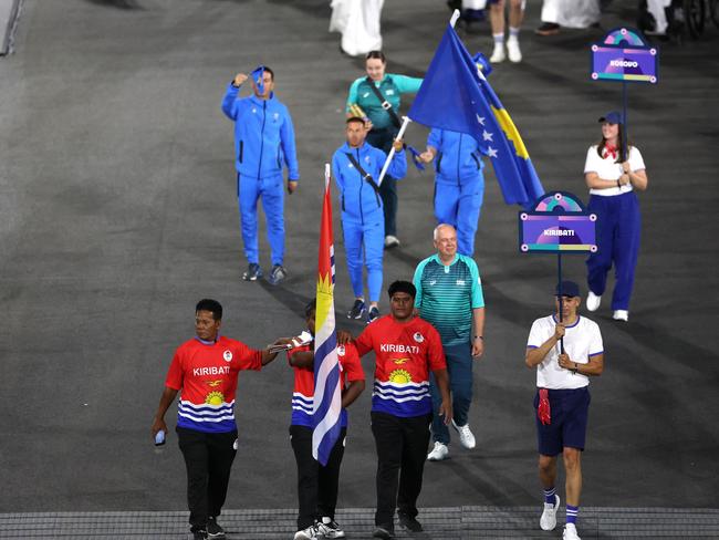 PARIS, FRANCE - AUGUST 28: Ongiou Timeon, Flag Bearer of Team Kiribati, holds their national flag as they parade during the opening ceremony of the Paris 2024 Summer Paralympic Games at Place de la Concorde on August 28, 2024 in Paris, France. (Photo by Elsa/Getty Images)