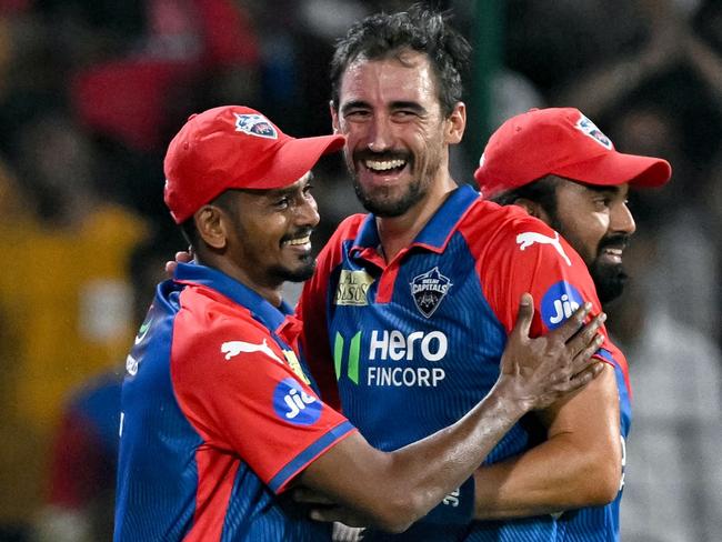 Delhi Capitals' Dushmantha Chameera (L) celebrates with Mitchell Starc (C) after taking a catch to dismiss Kolkata Knight Riders' Anukul Roy during the Indian Premier League (IPL) Twenty20 cricket match between Delhi Capitals and Kolkata Knight Riders at the Arun Jaitley Stadium in New Delhi on April 29, 2025. (Photo by Money SHARMA / AFP) / -- IMAGE RESTRICTED TO EDITORIAL USE - STRICTLY NO COMMERCIAL USE --