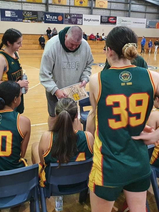 Jason coaching his daughter Scarlett’s basketball team. Picture: Supplied by family