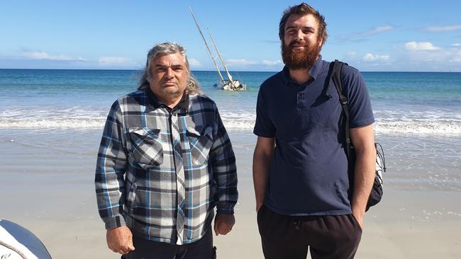 Claude Evans and son Samuel with their stranded yacht at North Haven., Picture: Colin James