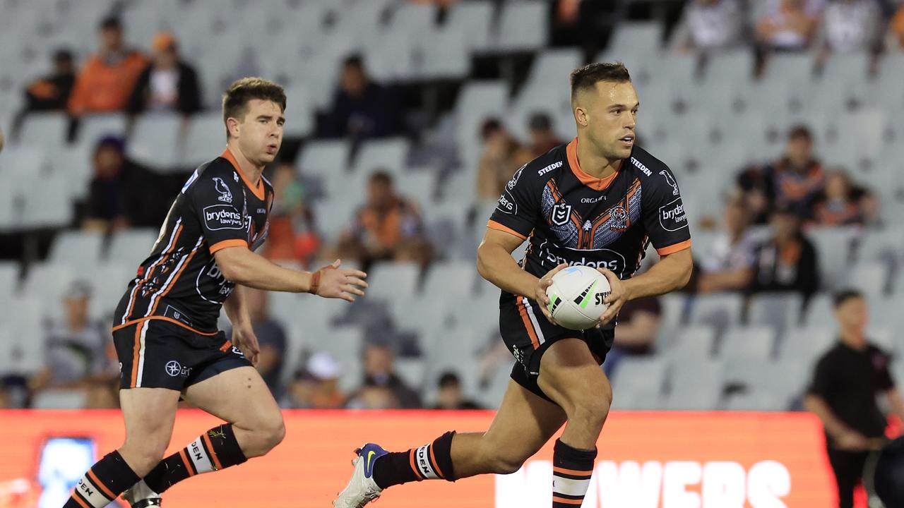 SYDNEY, AUSTRALIA - MARCH 25: Luke Brooks of the Tigers runs the ball during the round three NRL match between the Wests Tigers and the New Zealand Warriors at Campbelltown Stadium, on March 25, 2022, in Sydney, Australia. (Photo by Mark Evans/Getty Images)