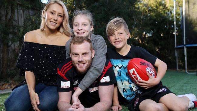 Retiring Brownlow medallist Adam and his wife Haylea and 2 of his 3 kids Ash and Jax relaxing at his Newport home. Pic: Michael Klein