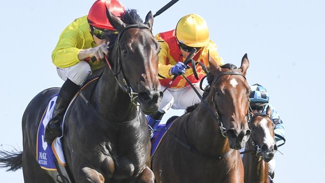 O' Ole (red cap) wins 2024 Magic Millions 2YO Classic from Memo (yellow cap), Horsehoe Hill (outside) and Tempestuous (rails) Picture: Bradley Photos