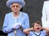 Britain's Prince Louis of Cambridge (R) holds his ears as he stands next to Britain's Queen Elizabeth II to watch a special flypast from Buckingham Palace balcony following the Queen's Birthday Parade, the Trooping the Colour, as part of Queen Elizabeth II's platinum jubilee celebrations, in London on June 2, 2022. - Huge crowds converged on central London in bright sunshine on Thursday for the start of four days of public events to mark Queen Elizabeth II's historic Platinum Jubilee, in what could be the last major public event of her long reign. (Photo by Daniel LEAL / AFP)