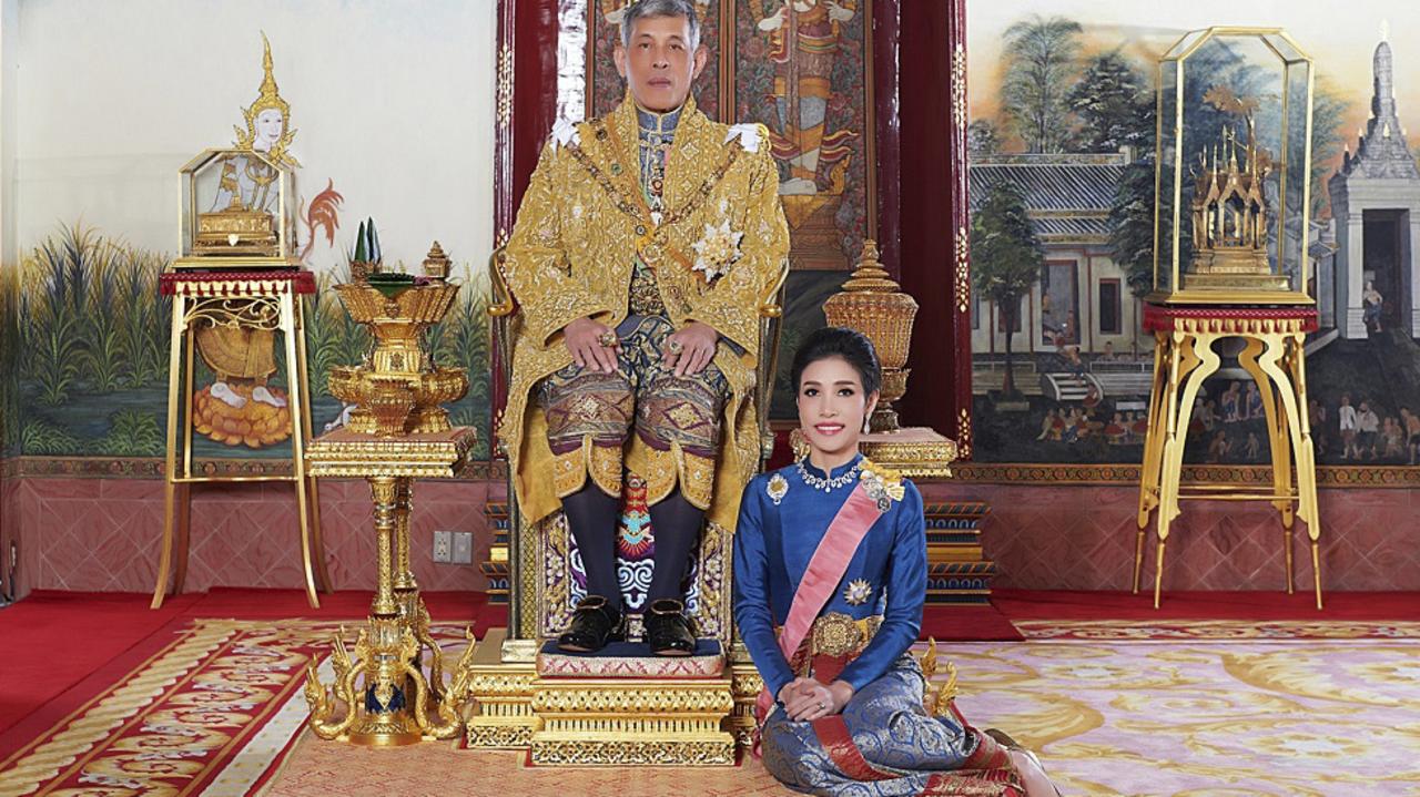 Thailand's King Maha Vajiralongkorn sits on the thrown with his former consort Sineenatra Wongvajirabhakdi. Picture: Thailand Royal Office via AP