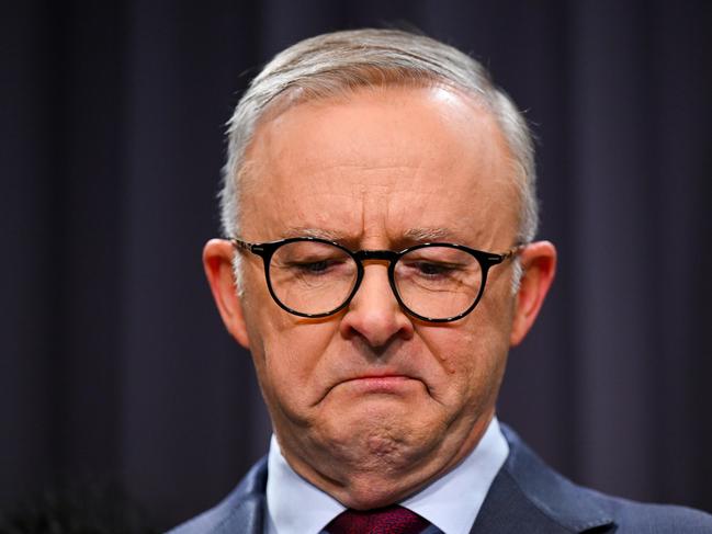 Australian Prime Minister Anthony Albanese surrounded by members of the First Nations Referendum Working Group gets emotional as he speaks to the media during a press conference at Parliament House in Canberra, Thursday, March 23, 2023. (AAP Image/Lukas Coch) NO ARCHIVING