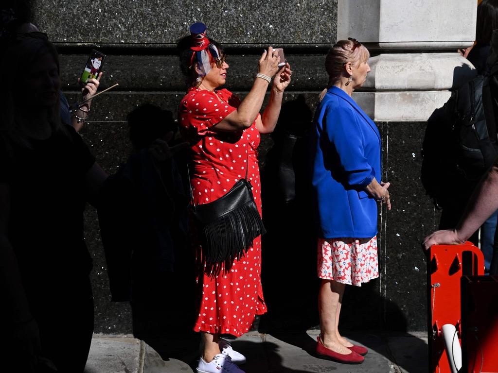 Royal fans are armed with their cameras eager to get a shot of history in the making. Picture: AFP