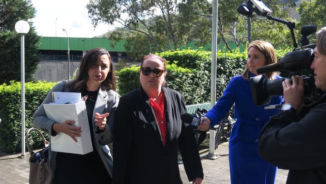 Maria Virgili (red shirt black suit) arrives at Gosford District Court for sentence. Picture: Richard Noone