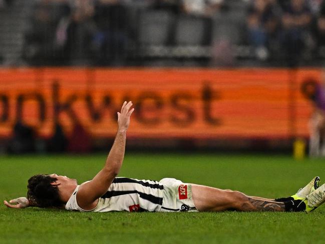 Lachie Schultz lies on the ground after a hit left him concussed. Picture: Getty Images