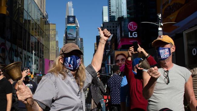 People ring bells as they celebrate at Times Square in New York. Picture: AFP