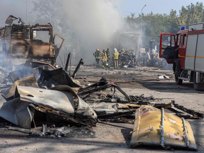TOPSHOT - Ukrainian firefighters extinguish a fire on a site following an air attack, in the Odesa region, on August 26, 2024, amid the Russian invasion of Ukraine. Russian drones and missiles on August 26, 2024 targeted 15 regions across Ukraine in an overnight barrage aimed mainly at energy infrastructure, Ukrainian Prime Minister Denys Shmygal said. (Photo by Oleksandr GIMANOV / AFP)