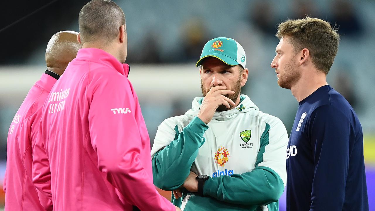 Jos Buttler of England and Aaron Finch of Australia speak with the umpires. Photo by Quinn Rooney/Getty Images