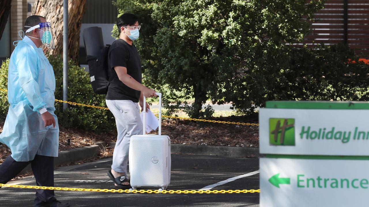 A returned traveller being evacuated from the Holiday Inn on Wednesday. Picture: NCA NewsWire/ David Crosling