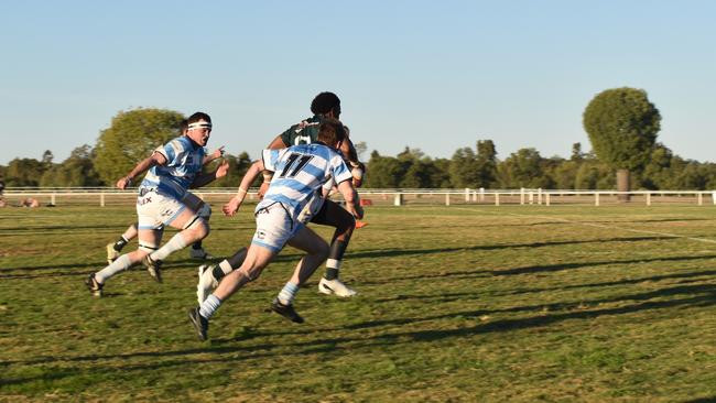 Spectators cheer on as they watch the A Grade Roma vs Condamine match at the Roma Rugby Races at Bassett Park. Picture: Chloe Cufflin.
