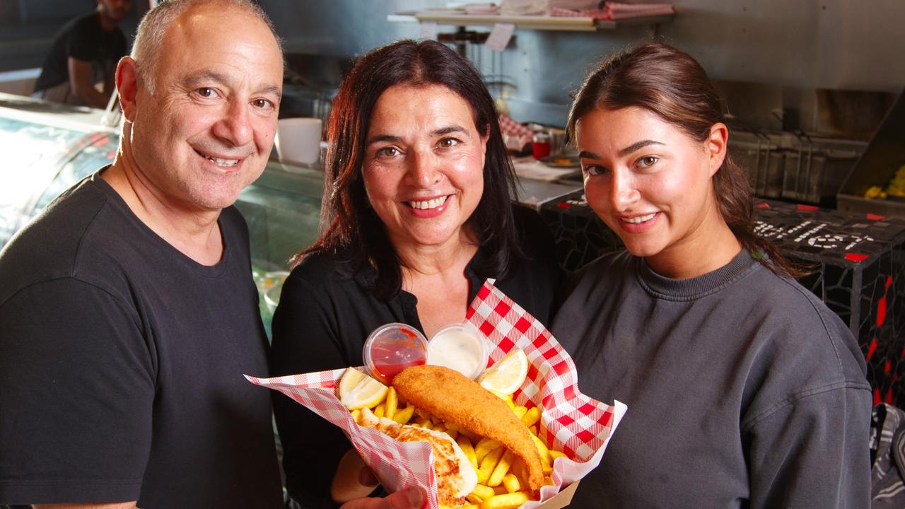 Dino, Amanda and Angelika Papadopoulos with their fish and chips at The Stunned Mullet, Henley Beach. Picture Matt Turner.