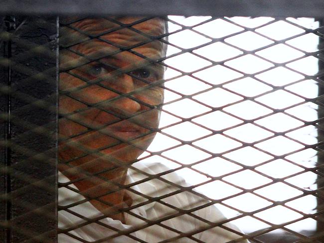 Al-Jazeera journalist Peter Greste looks out from the defendant's cage during a sentencing hearing in a courtroom in Cairo, yesterday. Picture: AP Photo/Ahmed Abd El Latif, El Shorouk Newspaper