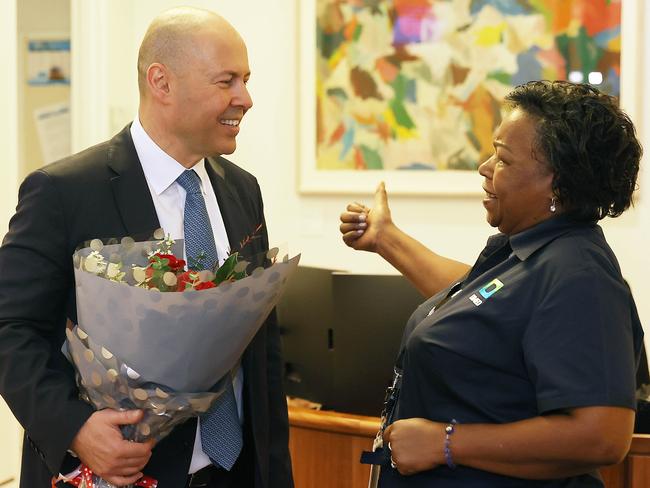 CANBERRA, AUSTRALIANewsWire Photos MARCH 29, 2022: The Treasurer Josh Frydenberg with Luzia Borges who gave him flowers, on the morning of the 2022 Budget, at Parliament House in Canberra.Picture: NCA NewsWire / Gary Ramage