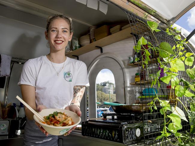 Chef and owner Emily Meredith holding a seafood pasta dish at Absorbed Co. Picture: Jerad Williams