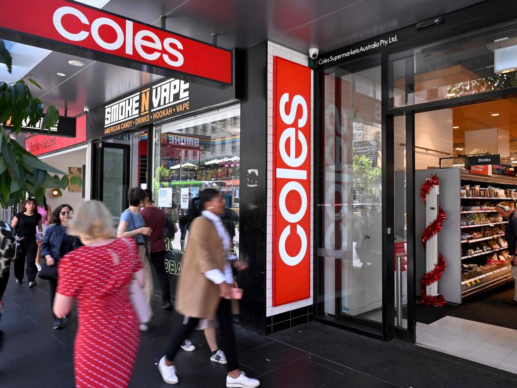 People walk past a Coles supermarket in Melbourne's central business district (CBD) on November 27, 2024. (Photo by William WEST / AFP)