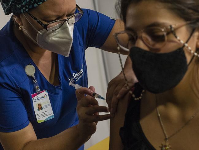 A woman receives the coronavirus vaccine in Brazil. Picture: Getty Images