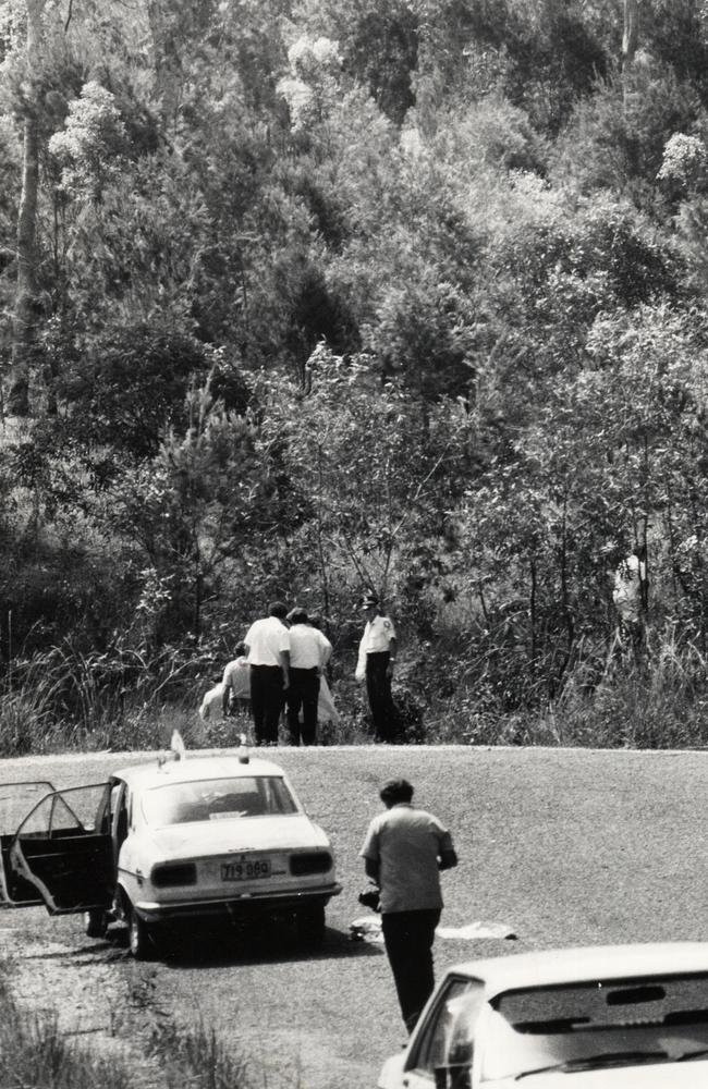 Police and government medical officers at the scene where the body of Linda Reed was found.