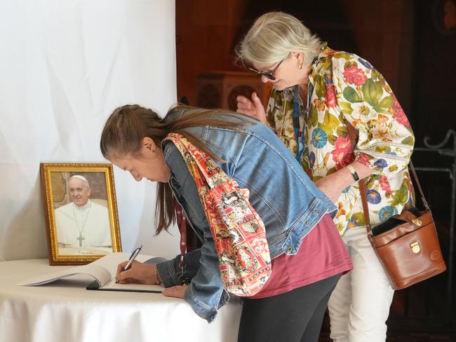 At St Francis Xavier Cathedral the faithful gather for Mass to give thanks for the life of Pope Francis, following his death on Monday. Karen De Sousa signing the condolence book. 22 April 2025. Picture: Dean Martin