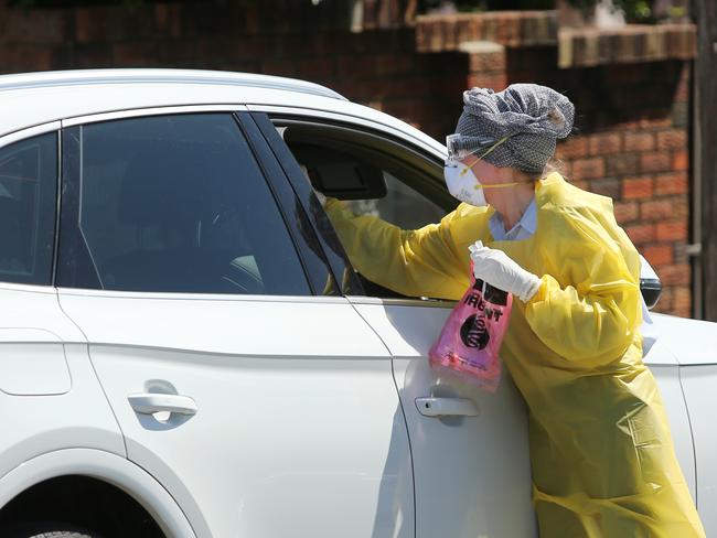 Pictured is a doctor  conducting drive up COVID-19 tests outside at General Practitioners at Maroubra in Sydney.Picture: Richard Dobson