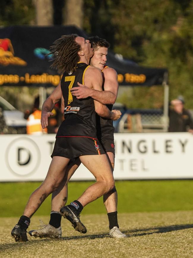 Dingley players celebrate a goal.