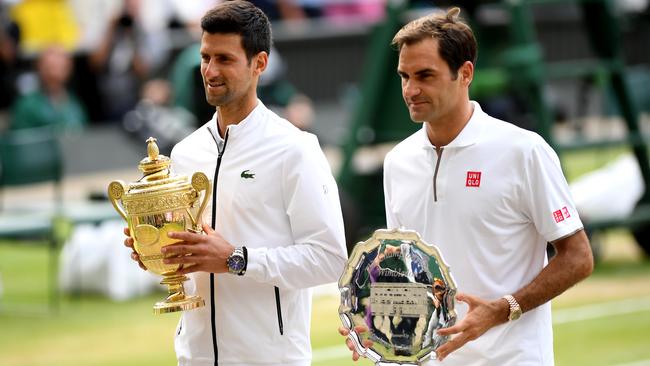 Novak Djokovic and Roger Federer pose for photos with their Wimbledon trophies. Picture: Getty Images