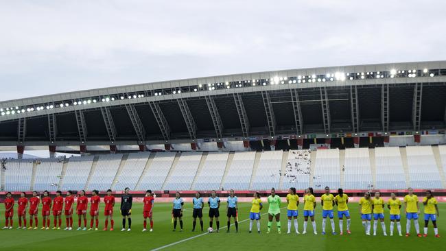 Teams stand for the national anthems prior to the Women’s First Round Group F match between China and Brazil in an empty Miyagi Stadium. Picture: Getty Images