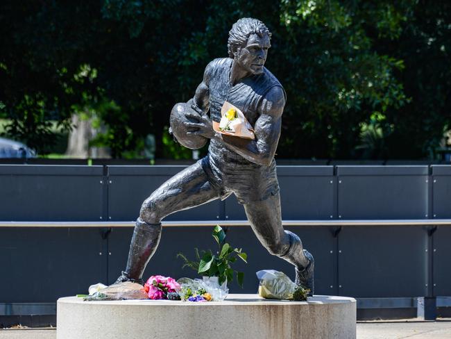 Flowers at the Russell Ebert statue at Adelaide Oval. Picture: Brenton Edwards