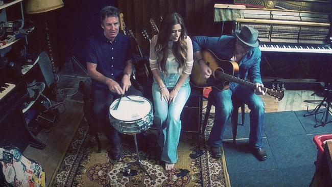 Midnight Oil's Rob Hirst, with daughter Jay and son-in-law Mark O'Shea on the set of their video for The Truth Walks Slowly. Picture: Supplied