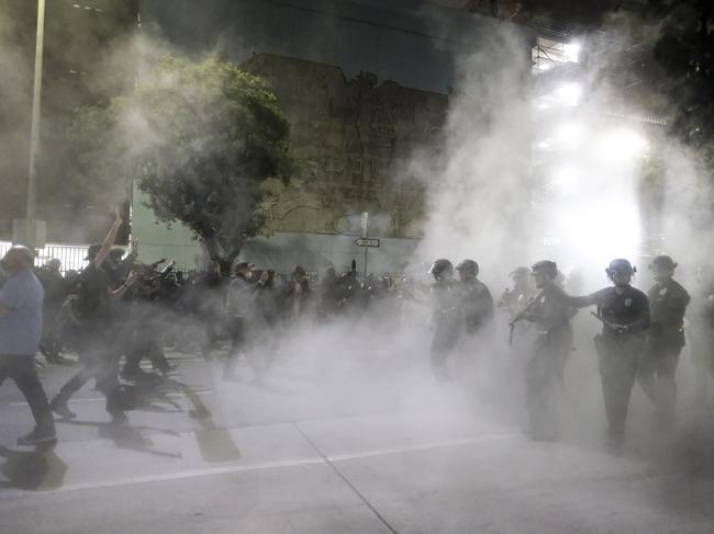 Police officers fire rubber bullets during a protest over the death of George Floyd in Los Angeles. Picture: AP