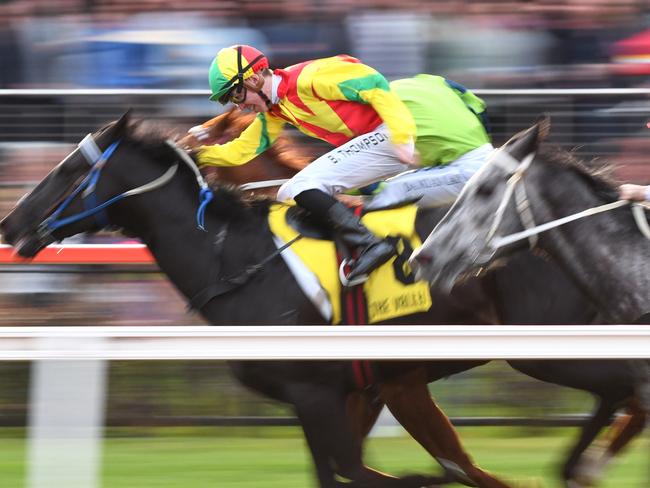 Ben Thompson drives Oak Door to the front to take out the final race at Moonee Valley. Picture: Getty Images