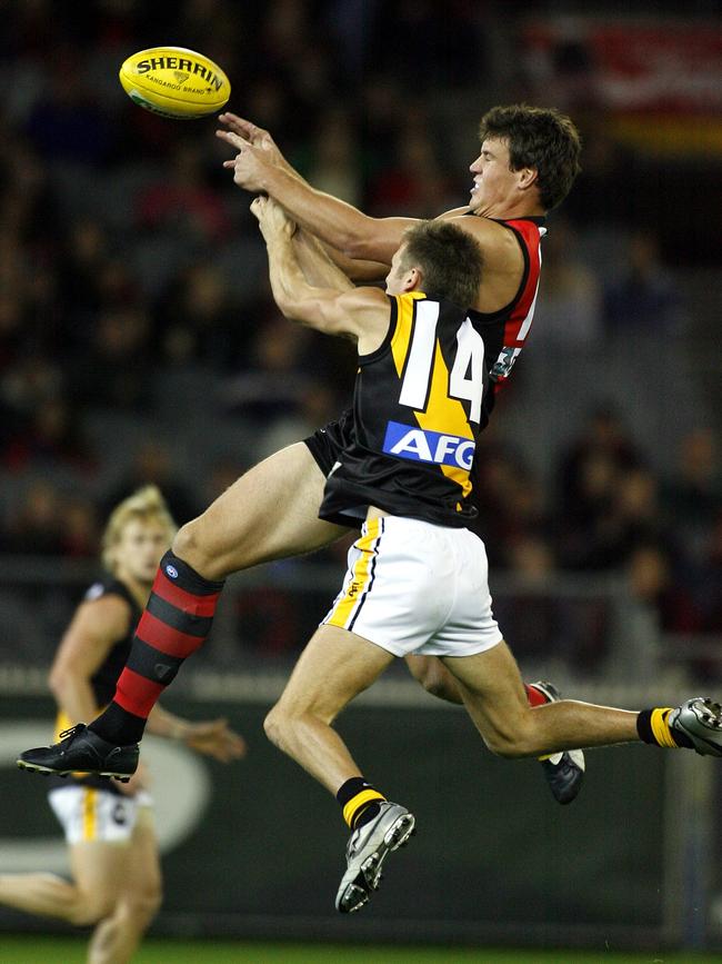 Dean Polo flies for a mark against David Hille during his record Richmond debut. 