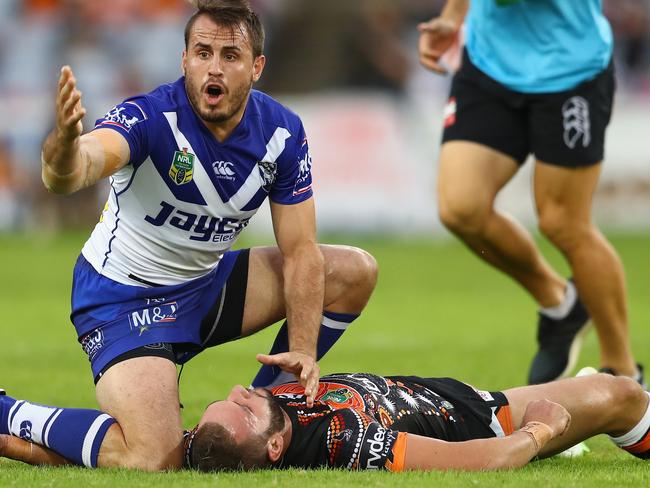 SYDNEY, AUSTRALIA - MAY 15: Josh Reynolds of the Bulldogs calls for assistance for an injured Robbie Farah of the Tigers during the round 10 NRL match between the Wests Tigers and the Canterbury Bulldogs at ANZ Stadium on May 15, 2016 in Sydney, Australia. (Photo by Mark Kolbe/Getty Images)