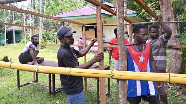 Workers assemble a makeshift polling station in Timika, Central Papua. Picture: AFP.