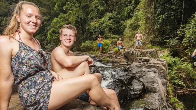 Gretel Lueddeke 20, and Michel Burmeister, 19, from Germany, relax with friends at Gardiners Falls on the Sunshine Coast. Tourists will soon have unprecedented access to southeast Queensland with four major airport expansions under way. Picture: Lachie Millard