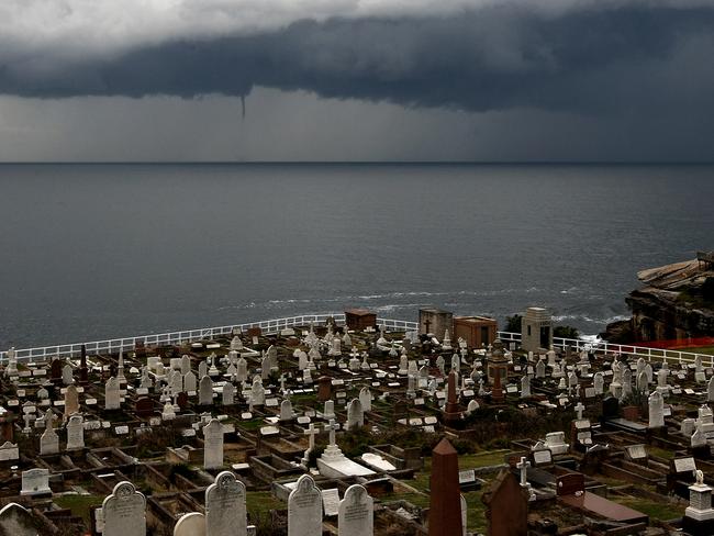 A water spout forms in storm clouds off coast of Sydney as seen when photographed from Eastern Suburbs Cemetary at Waverley.