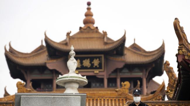 A resident looks out near the Yellow Crane Tower in Wuhan in central China's Wuhan province. Picture: AP Photo/Ng Han Guan.