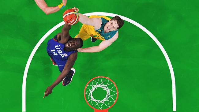 RIO DE JANEIRO, BRAZIL - AUGUST 10: Draymond Green #14 of United States grabs the rebound against Cameron Bairstow #10 and David Andersen #13 of Australia during the Men's Preliminary Round Group A between Australia and the United States on Day 5 of the Rio 2016 Olympic Games at Carioca Arena 1 on August 10, 2016 in Rio de Janeiro, Brazil. (Photo by Mark Ralston - Pool/Getty Images)