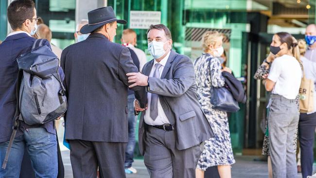 Former Logan City Mayor Luke Smith shakes Phil Pidgeon's hand as he leaves Brisbane Magistrates Court on April 14, 2021. Picture: Richard Walker