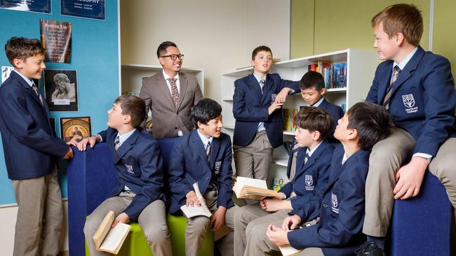 Ian Mejia, school principal at Hartford College, with some of the school students. Picture: Max Mason-Hubers