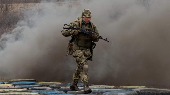 A Ukrainian military servicewomen runs takes part in a training drill at an undisclosed location in the eastern region of Ukraine. Picture: AFP