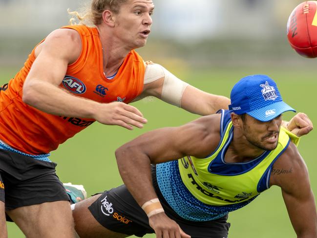 Aaron Hall, right, competes with Jed Anderson at North Melbourne training.